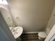 This powder room features a pedestal sink, toilet, and neutral paint at 35233 White Water Lily Way, Zephyrhills, FL 33541