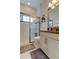 Bright bathroom with a glass-enclosed shower, white cabinets, and modern fixtures at 4372 Night Star Trl, Odessa, FL 33556