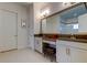 Elegant bathroom with dual vanities, a makeup area, and a large mirror at 4372 Night Star Trl, Odessa, FL 33556