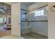 Modern bathroom featuring a glass-enclosed shower with a built-in bench and stylish tile work at 4372 Night Star Trl, Odessa, FL 33556