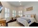 Cozy bedroom features shuttered windows, a comfortable chair, and a beautifully decorated bed at 4372 Night Star Trl, Odessa, FL 33556