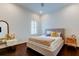 Minimalist bedroom featuring dark wood floors, a cozy bed, and a stylish accent chair at 4372 Night Star Trl, Odessa, FL 33556