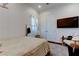 Bright bedroom featuring dark wood floors, a plush rug, and a wall-mounted television at 4372 Night Star Trl, Odessa, FL 33556