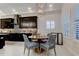 Bright dining area showcases a round table with stylish chairs and a view of the modern kitchen at 4372 Night Star Trl, Odessa, FL 33556