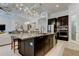 Open concept kitchen with a large island, pendant lighting, and stainless steel appliances at 4372 Night Star Trl, Odessa, FL 33556