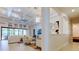 Light-filled living room with coffered ceiling, stylish lighting, expansive windows, and elegant decor at 4372 Night Star Trl, Odessa, FL 33556