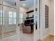 Comfortable home office with built-in shelving, a cozy chair, and ample natural light at 4372 Night Star Trl, Odessa, FL 33556