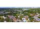 A tranquil aerial shot shows the home surrounded by lush greenery within a vibrant community at 500 62Nd S St, St Petersburg, FL 33707