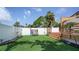 Well-maintained backyard with artificial turf, landscaping, and a charming deck area at 500 62Nd S St, St Petersburg, FL 33707