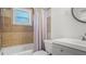 Cozy bathroom with a shower-tub combo, white vanity, and a window at 500 62Nd S St, St Petersburg, FL 33707