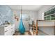 Sunlit bedroom showcasing a hanging chair, bunk beds, and a window with natural views at 500 62Nd S St, St Petersburg, FL 33707