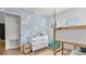 Bright bedroom features a wave accent wall, modern dresser, and a whimsical hanging chair at 500 62Nd S St, St Petersburg, FL 33707
