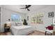 Bright bedroom featuring a ceiling fan, two windows, and a calm, relaxing atmosphere at 500 62Nd S St, St Petersburg, FL 33707