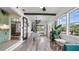 Bright dining room with a spiral staircase, views from the many large windows, and modern furnishings at 500 62Nd S St, St Petersburg, FL 33707