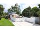 A fenced-in yard ensures privacy, while a charming awning provides shade to an outdoor seating area at 500 62Nd S St, St Petersburg, FL 33707