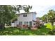Charming two-story home boasts a welcoming porch, lush lawn, and mature trees for a serene setting at 500 62Nd S St, St Petersburg, FL 33707