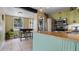 Bright kitchen with breakfast bar, stainless steel appliances, and direct access to the laundry area at 500 62Nd S St, St Petersburg, FL 33707