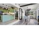 Open-concept living space with modern kitchen, dining area, and staircase at 500 62Nd S St, St Petersburg, FL 33707