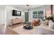 Cozy living room with wood floors, a comfortable sofa, decorative accents, and plenty of natural light at 500 62Nd S St, St Petersburg, FL 33707