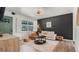 Living room featuring a textured rug, stylish coffee table, modern fan, and a window with white shutters at 500 62Nd S St, St Petersburg, FL 33707