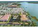 Expansive aerial view showcasing condo building, water view, and community pool at 7903 Seminole Blvd # 2203, Seminole, FL 33772