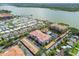 Stunning aerial view of lakeside condo community with a pool, lake, and mature trees at 7903 Seminole Blvd # 2203, Seminole, FL 33772