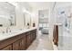 Bright bathroom with a double sink vanity and glass enclosed shower that leads to a serene bedroom at 7903 Seminole Blvd # 2203, Seminole, FL 33772