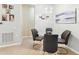 Cozy dining area with seating for four features a modern chandelier, artwork, and pet portraits at 7903 Seminole Blvd # 2203, Seminole, FL 33772
