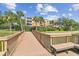 Tranquil view from the wooden dock with a seating bench overlooking the lake at 7903 Seminole Blvd # 2203, Seminole, FL 33772