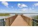 Scenic view of the lake from the dock with a wooden walkway and metal railings at 7903 Seminole Blvd # 2203, Seminole, FL 33772