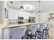 Bright and airy kitchen with a breakfast bar, stainless steel appliances, and white cabinetry at 7903 Seminole Blvd # 2203, Seminole, FL 33772