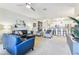 Open-concept living room with contemporary furnishings, a ceiling fan, and seamless flow to the modern kitchen at 7903 Seminole Blvd # 2203, Seminole, FL 33772