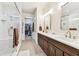 Luxurious main bathroom with dual sinks, a glass-enclosed shower, and access to the walk-in closet at 7903 Seminole Blvd # 2203, Seminole, FL 33772