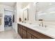 Elegant main bathroom with dual sinks, a glass-enclosed shower, and access to the walk-in closet at 7903 Seminole Blvd # 2203, Seminole, FL 33772