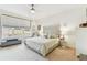 Calm and inviting main bedroom features neutral tones, a large window, and a decorative headboard at 7903 Seminole Blvd # 2203, Seminole, FL 33772