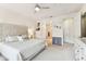 Bright main bedroom features neutral tones, a large window, and access to the ensuite bathroom and walk-in closet at 7903 Seminole Blvd # 2203, Seminole, FL 33772