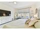 Bright main bedroom features neutral tones, a large window, a dresser, and a decorative headboard at 7903 Seminole Blvd # 2203, Seminole, FL 33772