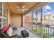 Relaxing screened patio featuring comfortable seating and a ceiling fan, perfect for enjoying the outdoors at 7903 Seminole Blvd # 2203, Seminole, FL 33772