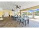 Inviting pool area with tables and chairs under a covered patio with ceiling fans at 7903 Seminole Blvd # 2203, Seminole, FL 33772