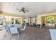 A covered pool area features tables, chairs, ceiling fans, and access to the swimming pool at 7903 Seminole Blvd # 2203, Seminole, FL 33772