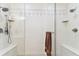Glass shower enclosure featuring dual shower heads, built-in shelves, and mosaic tile flooring at 7903 Seminole Blvd # 2203, Seminole, FL 33772