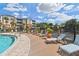 Resort-style pool deck with lounge chairs, a manicured landscape, and a fountain view create a tranquil recreational space at 7903 Seminole Blvd # 2203, Seminole, FL 33772