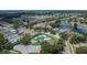 Aerial view of a community featuring homes, a pool, and a pond at 8620 Sandy Plains Dr, Riverview, FL 33578