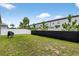 Large backyard with a mix of green grass and a black fence to add privacy to the property at 8620 Sandy Plains Dr, Riverview, FL 33578