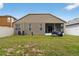A spacious backyard with green grass and a view of the home's rear exterior at 8620 Sandy Plains Dr, Riverview, FL 33578