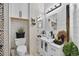 Stylish bathroom with a vanity, vessel sink, elegant mirror, tiled wall accents, and modern lighting at 8620 Sandy Plains Dr, Riverview, FL 33578