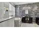 Modern bathroom with a soaking tub, stone accent wall, vessel sink, and storage at 8620 Sandy Plains Dr, Riverview, FL 33578