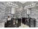 Stylish bathroom featuring double vanities with vessel sinks and a stone accent wall at 8620 Sandy Plains Dr, Riverview, FL 33578