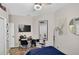 This bedroom features a ceiling fan, a flat-screen television, and a black office chair at 8620 Sandy Plains Dr, Riverview, FL 33578
