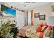 This bedroom features a ceiling fan, a flat-screen television, and orange accents at 8620 Sandy Plains Dr, Riverview, FL 33578